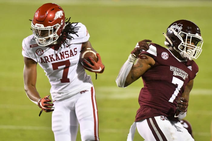 Oct 3, 2020; Starkville, Mississippi, USA; Arkansas Razorbacks wide receiver Trey Knox (7) runs the ball defended by Mississippi State Bulldogs safety Marcus Murphy (7) during the second half at Davis Wade Stadium at Scott Field. Mandatory Credit: Matt Bush-USA TODAY Sports